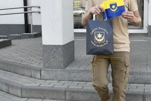 Druh OSP KSRG Dawid Borkowski z gadżetami promocyjnymi Gminy Stryków przezd udziałem w Sky Tower Run 2024